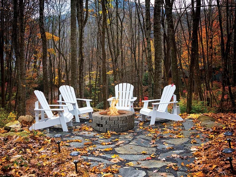 A finished fire pit burning on an autumn evening