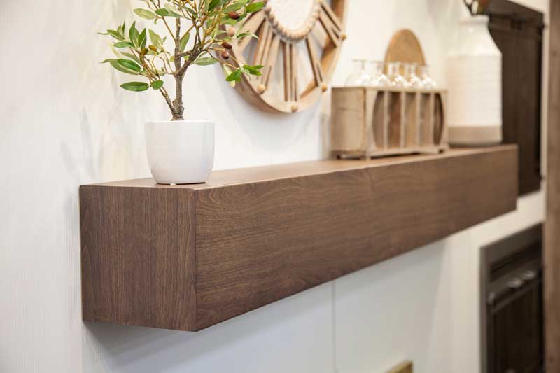 Stoll wood-grain mantel shelf installed above a fireplace
