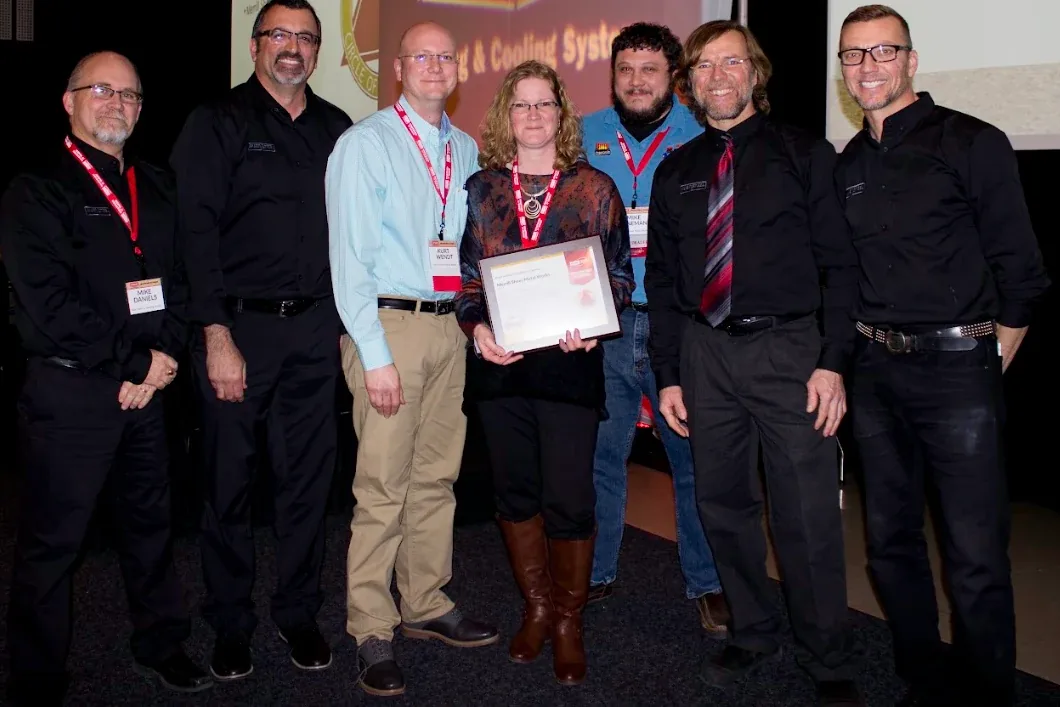 The family crew on stage accepting a dealer award — Kurt Wendt among them, certificate in hand