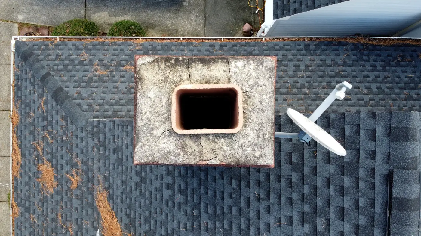 A chimney crown seen from directly above — cracked crown, open flue: exactly what an inspection catches